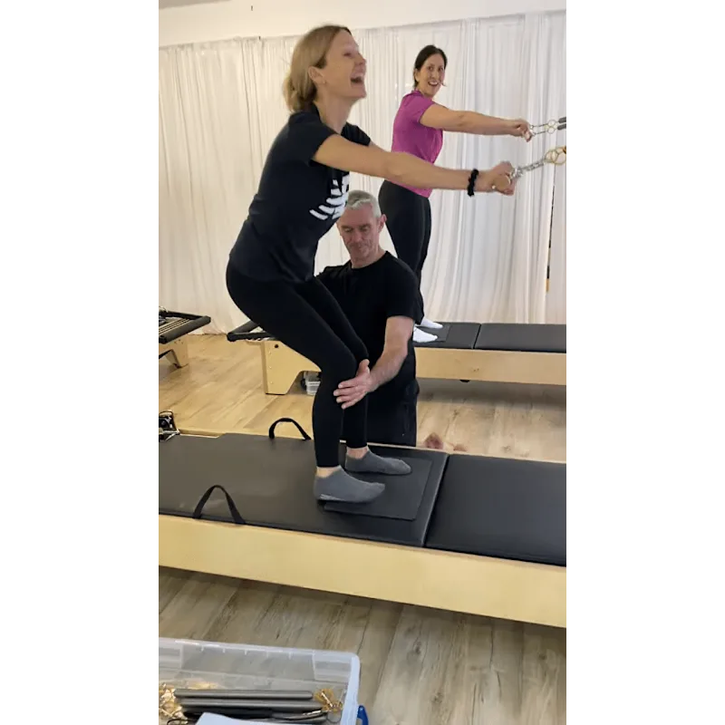 students on a reformer laughing Reformer Teacher Training Bodmin Cornwall