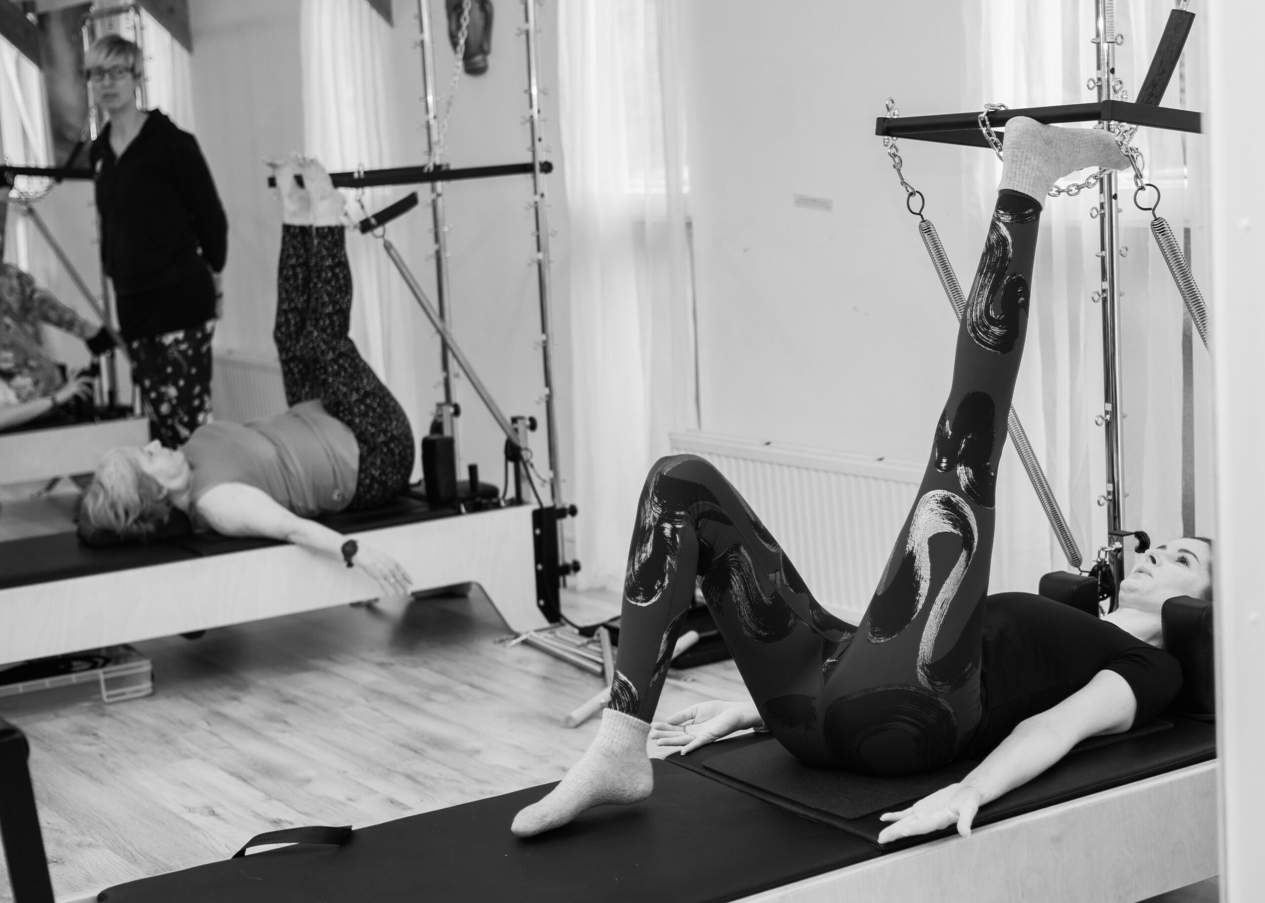 Pilates Tower Teacher Training instructor using the half cadillac trapeze